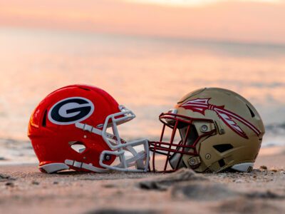 A Georgia Football Helmet and Florida State Football Helmet on the Beach